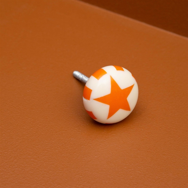 Knob with orange star